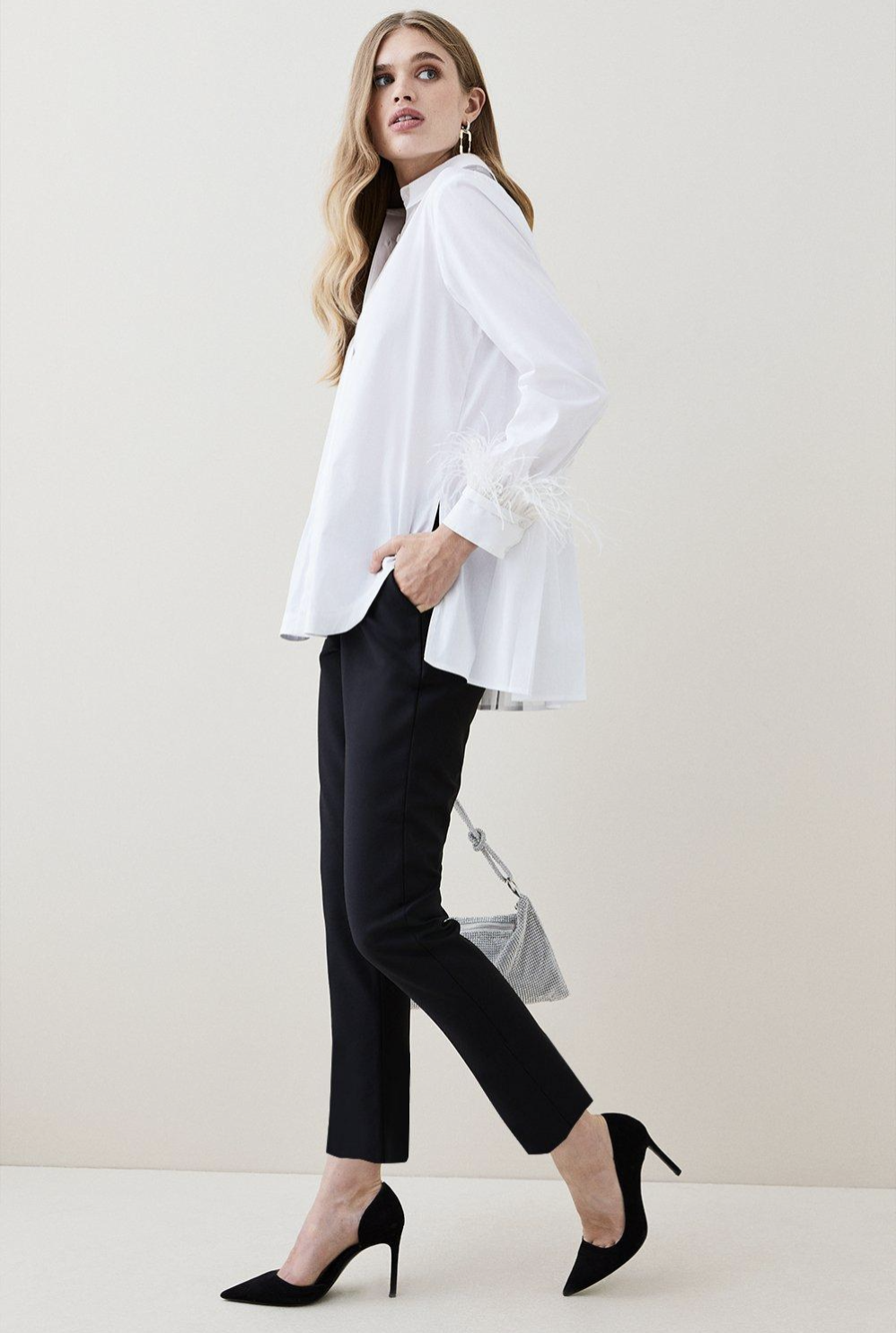 woman wearing woven black pants and white button top, fashion trends for women over 50